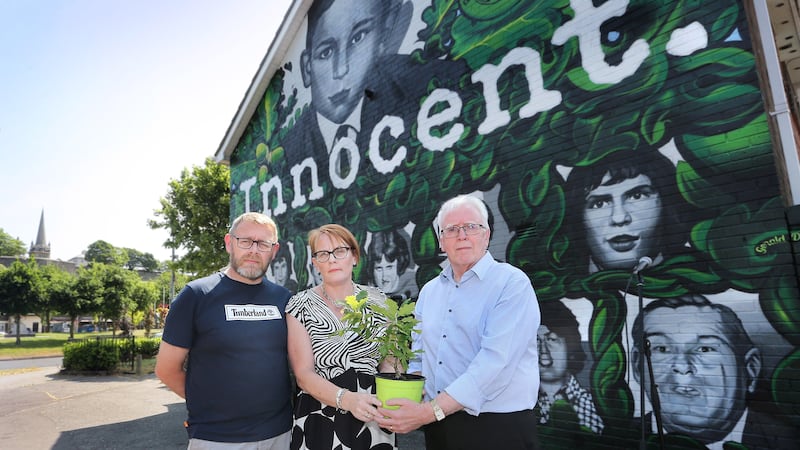 Geraldine Doherty and her brother Denis were presented with an Oak plant after Ms Doherty unveiled a new mural highlighting her uncle, Bloody Sunday victim, Gerald Donaghey's (pictured at top of mural) innocence. Picture by Margaret McLaughlin