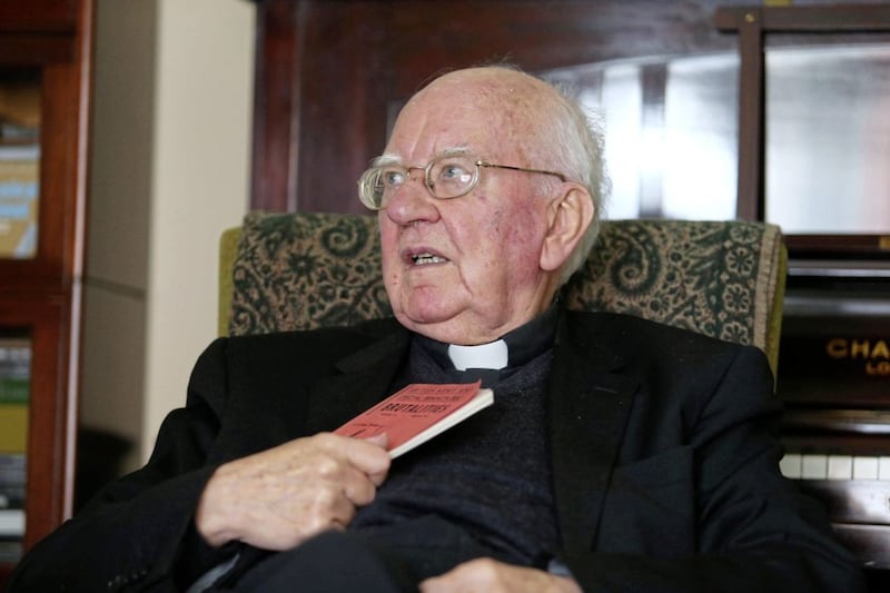 Monsignor Raymond Murray with one of the pamphlets he wrote with Fr Denis Faul. Picture by Mal McCann