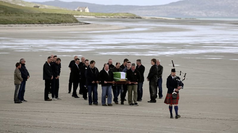 The coffin of Eilidh MacLeod draped in the Barra flag is carried across Traigh Mhor beach at Barra airport after it arrived by chartered plane. PICTURE: Andrew Milligan, Press Association 