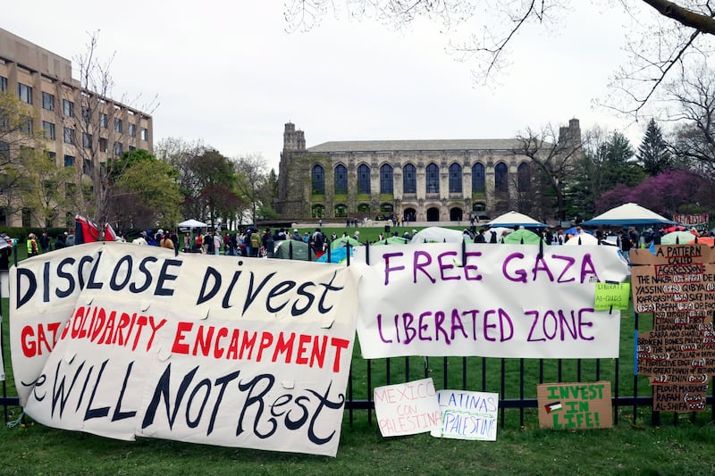 Signs are displayed outside a tent encampment at Northwestern University in Evanston, Illinois (Teresa Crawford/AP)