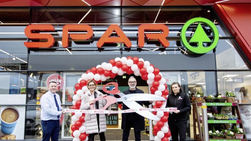 Colin Cunningham, Helen and Gavan Wall, and Emma Morrow from The Wall Group outside the Landscape filling station Spar NI store open on Belfast&#39;s Crumlin Road 