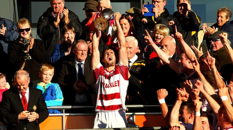 Chrissy McKaigue lifts the Four Seasons Cup at the Athletic Grounds in October &nbsp;