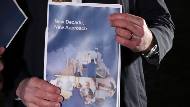 Secretary of State Julian Smith holds the New Decade, New Approach document outside Stormont