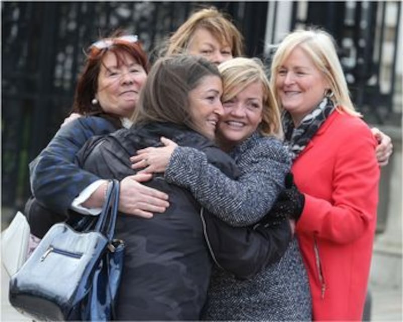 Deborah McGuinness (centre), who took the case, celebrates with friends and family outside the court. Picture by Hugh Russell.