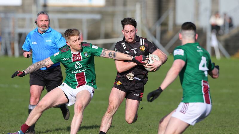Down's Ceilum Doherty keeps possession while under pressure from Luke Loughlin of Westmeath
Picture: Louis McNally