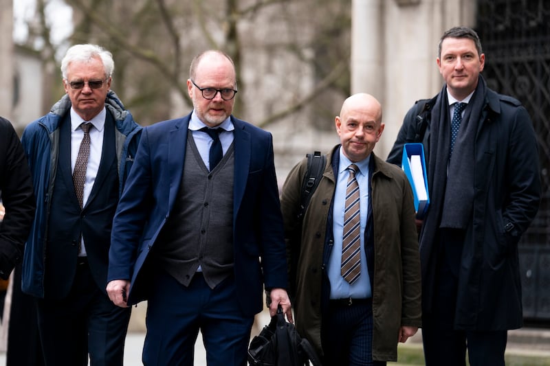 Journalists Trevor Birney (center left) and Barry McCaffrey (center right) outside the Royal Courts of Justice in London. John Finnucane is to Barry's right.