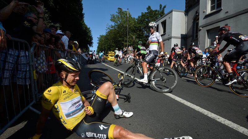 Germany's Tony Martin, wearing the overall leader's jersey, lies on the road with a broken collar bone after crashing in the last stretch of the sixth stage of the Tour de France on Thursday<br />Picture: AP