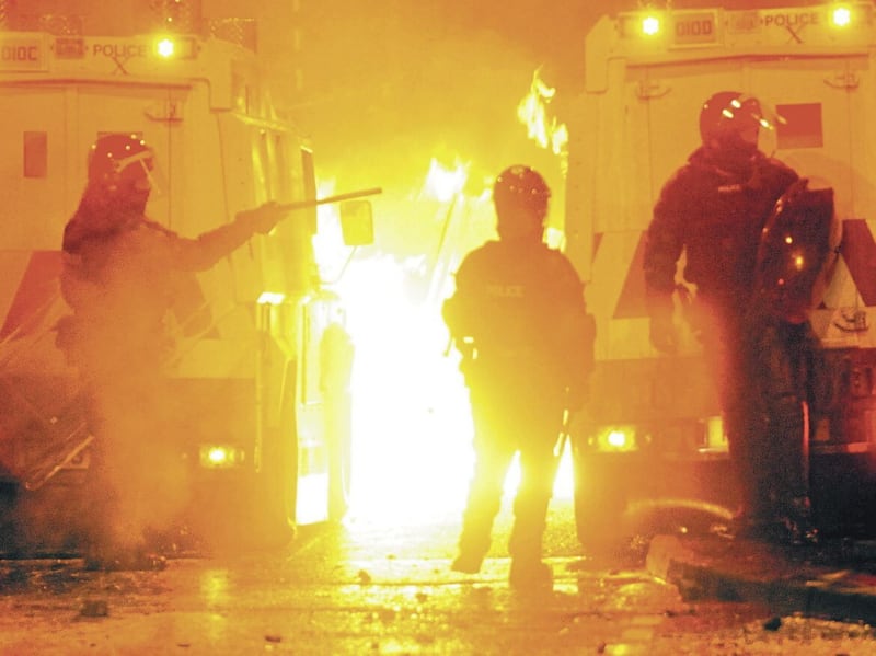Police come under petrol bomb attack from rioting flag protesters in the Rathcoole area outside north Belfast in 2013 