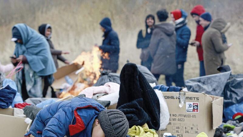 A child collects toys near a clothes donating point as refugees fleeing conflict in Ukraine arrive at the Medyka border crossing in Poland (AP Photo/Visar Kryeziu). 