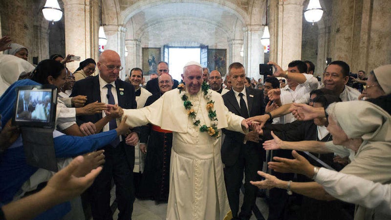 In this photo taken on Sunday, Sept. 20, 2015, Pope Francis is greeted by faithful as he enters the San Cristobal Cathedral, Havana, Cuba. Francis presided over the evening prayer service in Havana&#39;s 18th century cathedral, where he broke from prepared remarks and spoke off-the-cuff at length for the first time during his trip to Cuba. (L&#39;Osservatore Romano/Pool Photo via AP) 