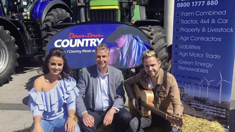 Mark Mahaffy (centre), regional managing director at Cool FM and Downtown Radio, with country stars Lisa McHugh and Derek Ryan at the launch of Ireland&#39;s first-ever &lsquo;Farmers Bash&rsquo; planned for October. Downtown&#39;s dedicated country radio station passed the landmark 100,000 listener mark in Q1 