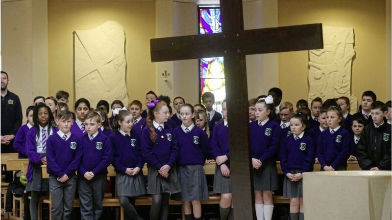 Pupils and staff from six schools joined for the Stations of the Cross at Holy Family Church in north Belfast. Picture by Hugh Russell. 