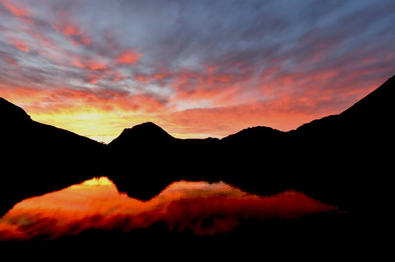 A fire glow at sunrise over Buttermere in the Lake District.