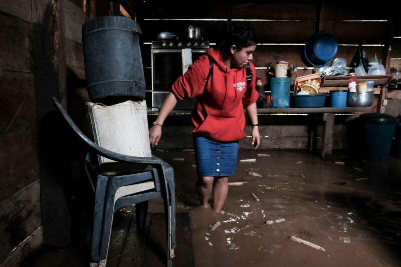 A woman walks into her house, flooded during the passage of Hurricane Iota in Siuna, Nicaragua, on November 17&nbsp;2020. Picture by Carlos Herrera, AP