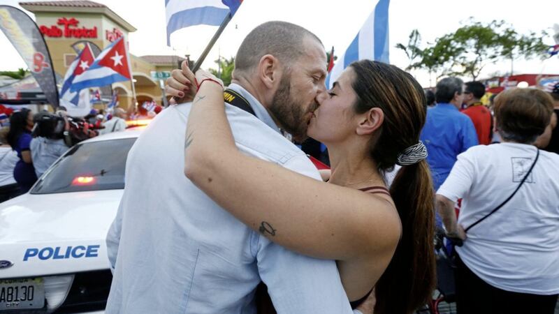 Spanish newlyweds Daniel Aznar, left, and Iris Morata kiss as they attend an anti-Castro rally of hundreds of Cuban exiles in Little Havana, Miami. Picture by Wilfredo Lee, Associated Press 