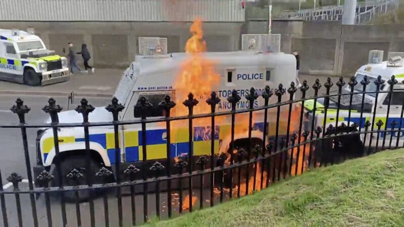 A police vehicle is hit by a petrol bomb thrown from inside Derry&#39;s City Cemetery 