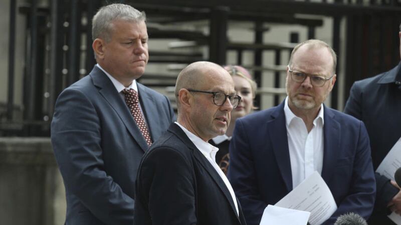 Journalists Trevor Birney (right) and Barry McCaffrey (centre) speak to the press outside the Hight Court in Belfast today as solicitor Niall Murphy (left) looks on. Picture by Hugh Russell&nbsp;