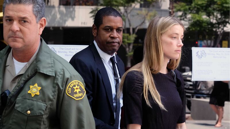 Actress Amber Heard leaves Los Angeles Superior Court court after giving a sworn declaration that her husband Johnny Depp threw her phone at her during a fight Saturday, striking her cheek and eye. Picture by&nbsp;Richard Vogel, Associated Press&nbsp;
