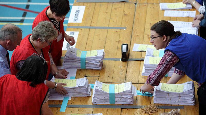 Stacking up the ballot papers at the Ballymena count. Picture by Cliff Donaldson. 