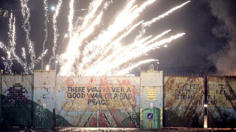 A firework explodes at the peace line at Lanark Way in west Belfast. (AP Photo/Peter Morrison). 
