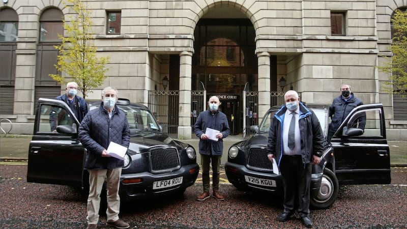 Taxi driver representatives handing a letter of protest into the Department for Infrastructure in Belfast. Picture Mal McCann. 