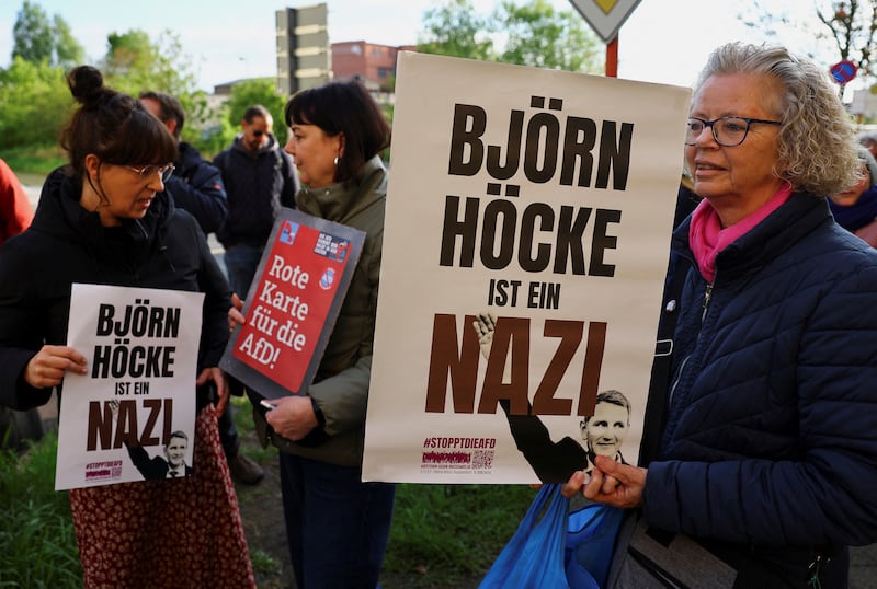 Protesters hold banners reading ‘Bjorn Hocke is a Nazi’ outside the state court in Halle, Germany (Fabrizio Bensch/AP)
