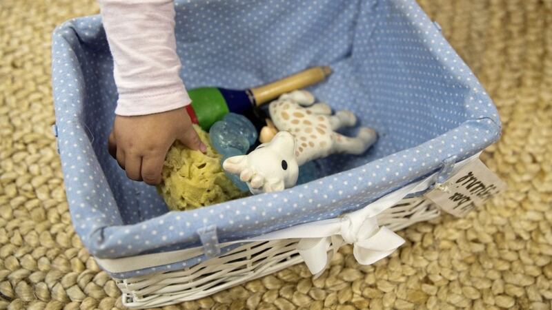 A child takes out a toy from a &#39;bite box&#39; at the Tops Day Nursery. Picture by Andrew Matthews/PA Wire 