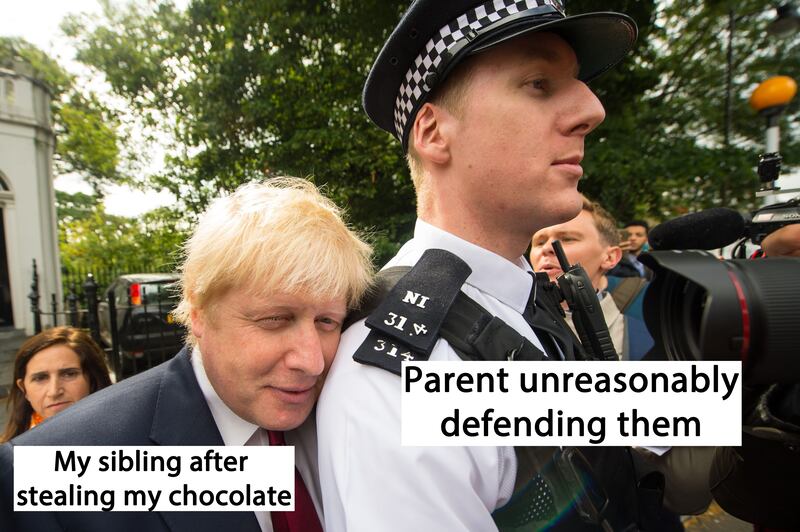 Boris Johnson being protected by a policeman
