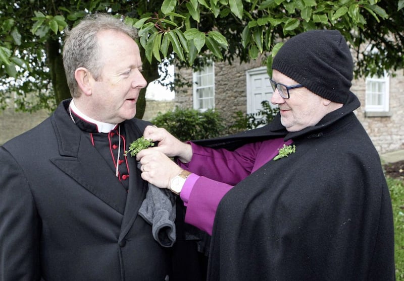 Catholic Archbishop of Armagh Eamon Martin and Church of Ireland Archbishop of Armagh Richard Clarke help each other out at the&nbsp;St Patrick's Day Parade in Armagh. Picture by Freddie Parkinson/Press Eye