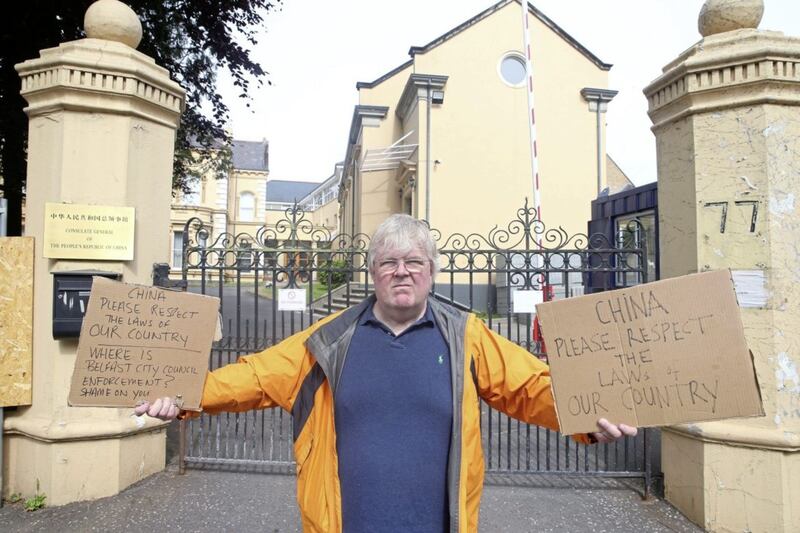 Resident Martin McBurney protests at the ongoing work on a wall surrounding the Chinese Consulate on Malone Road in south Belfast. Picture by Mal McCann 