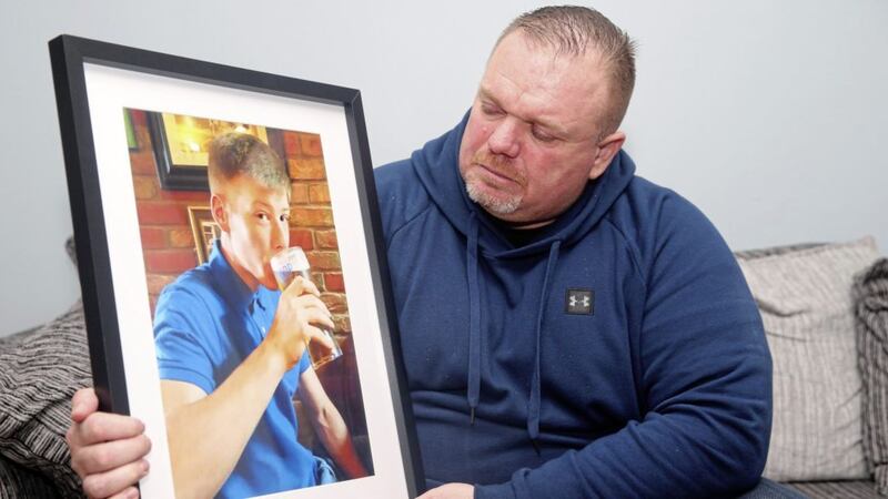 Christopher Connor holds a picture of Aaron (21) who died on Saturday. Picture by Mal McCann 