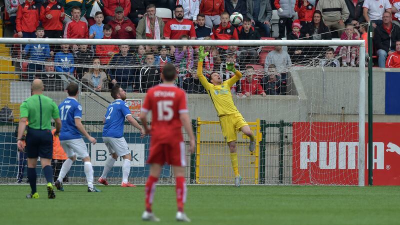 George McMullan's chip soars over Ross Glendinning in the Linfield goal at Solitude last Saturday<br />Picture: Pacemaker &nbsp;