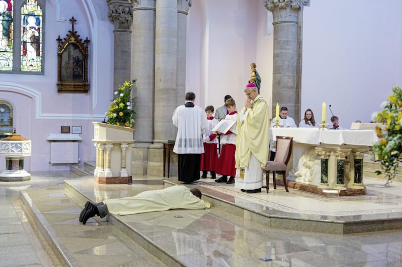 Martin Donnelly, who was ordained to the Diaconate at St Michael&#39;s Church, Enniskillen, lies prostrate before Bishop Alan McGuckian. Picture by Ronan McGrade 