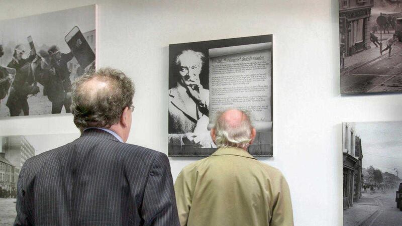 Playwright Brian Friel inspects a piece of his own work, displayed at the Bogside Gallery in Derry, with John Hume. Picture by Margaret McLaughlin 