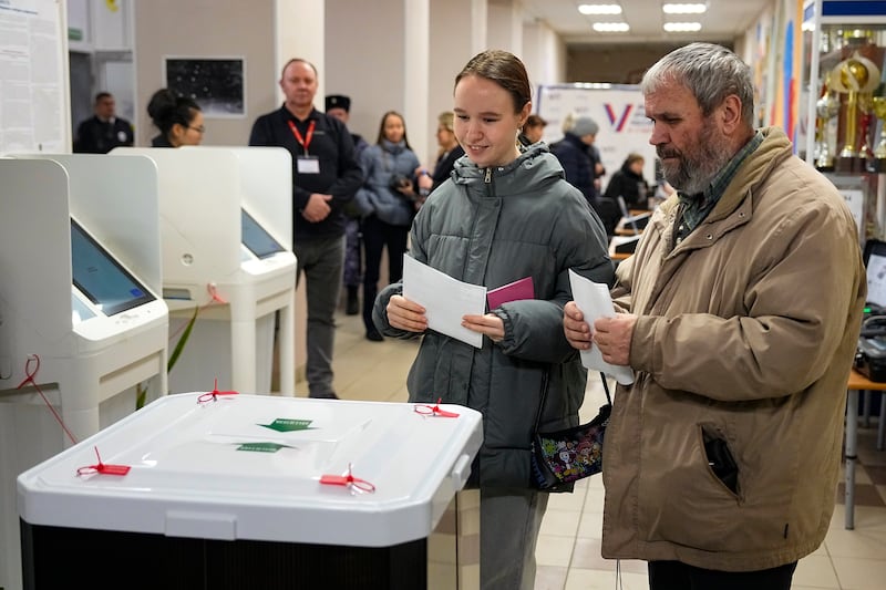 People vote during the presidential election in Moscow