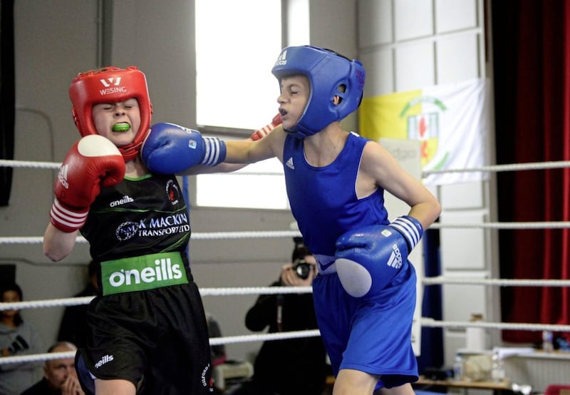 Lennan McGavigan (Gilford) and Cormac Fegan (Holy Trinity) trade blows during their NI Schoolboys (CYP) championship final at Corpus Christi at the weekend. Picture by Mark Marlow 