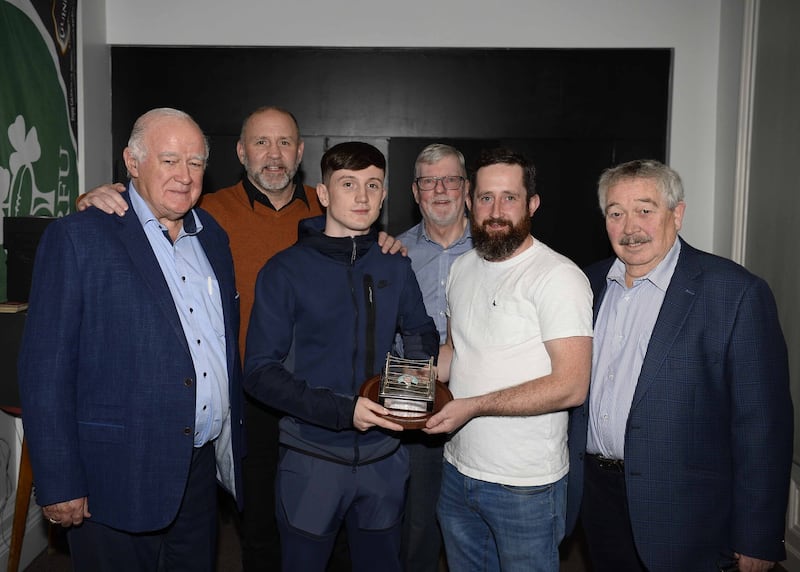 Hugh Russell junior presents Boxer of the Year Conor Quinn with the Eddie Shaw Trophy