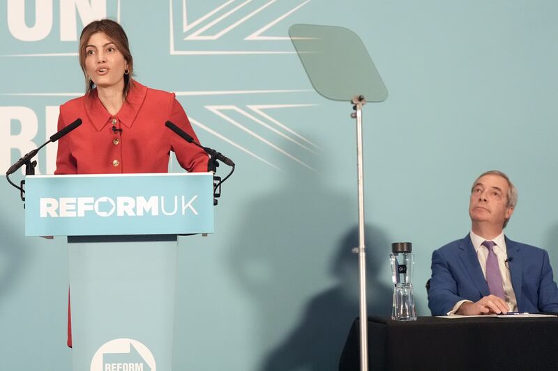 Reform UK’s Laila Cunningham speaking as party leader Nigel Farage looks on during a press conference at Glazier’s Hall Southwark, south London