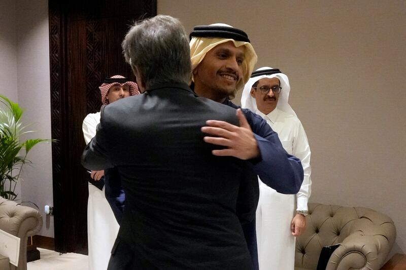 US Secretary of State Antony Blinken, left, is welcomed by Qatar’s Prime Minister and Foreign Affairs Minister Mohammed Bin Abdulrahman Al Thani in Doha, Qatar (Mark Schiefelbein/Pool/AP)