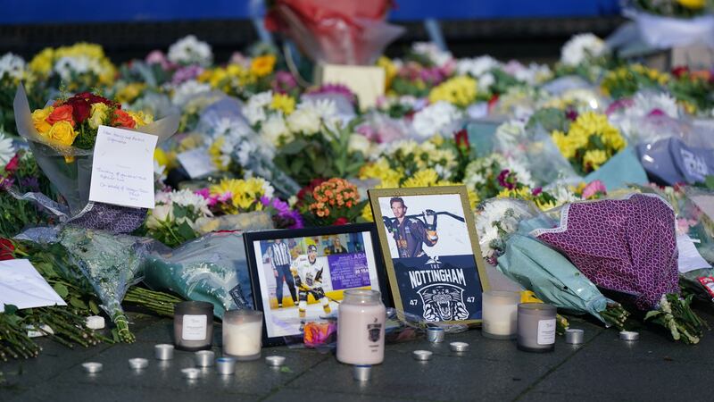 Lit candles among the flowers and messages left in tribute to Nottingham Panthers’ ice hockey player Adam Johnson (Jacob King/PA)