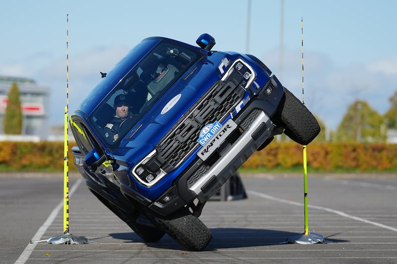 Paul Swift achieves the Guinness World Record for 'The tightest gap driven through on two wheels in a pick up truck (88cm)' in celebration of Guinness World Records Day 2023