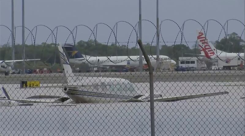 This image from a video shows partially-submerged small planes at Cairns Airport (Australian Broadcasting Corp via AP)