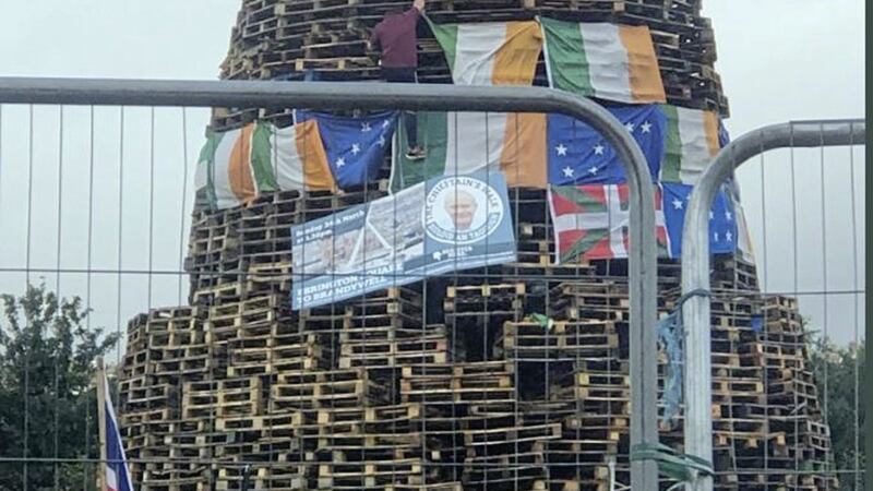 A picture of the late Martin McGuiness was placed on a loyalist bonfire in Derry last night in a move which was described as `sickening&#39; 