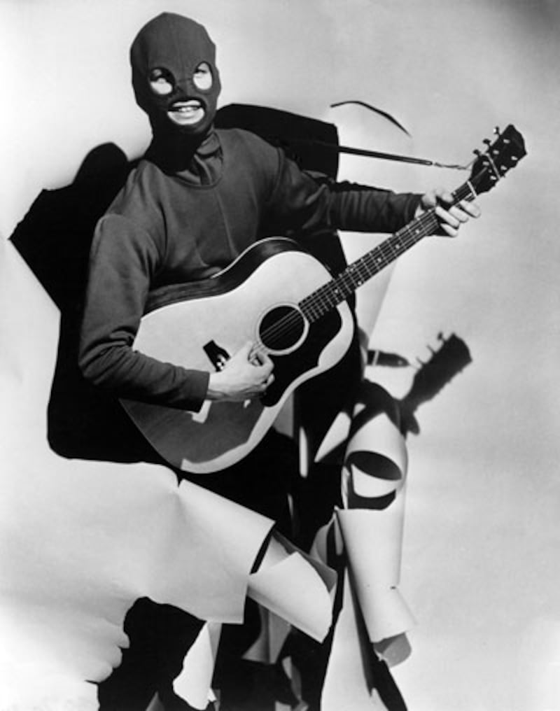 A young, balaclava-clad David Soul poses with his guitar as The Covered Man