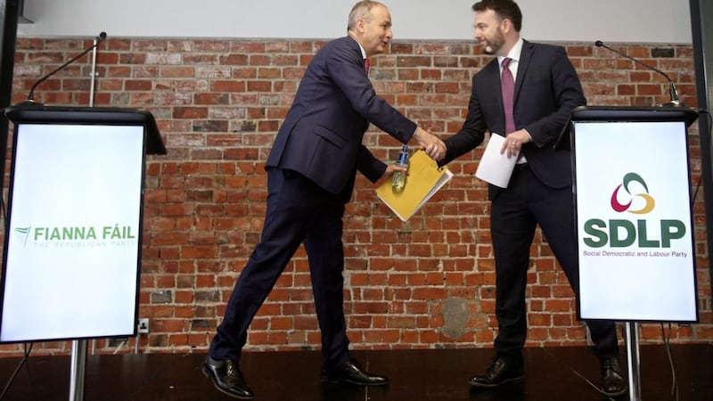 Colum Eastwood of the SDLP and Miche&aacute;l Martin of Fianna F&aacute;il shake hands in Belfast on the deal that brings the two parties closer together - but at what cost? Picture by Mal McCann 