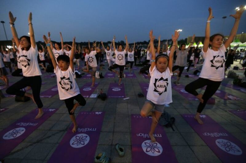 Children perform yoga to mark the International Day of Yoga in Seoul, South Korea (Ahn Young-joon/AP)
