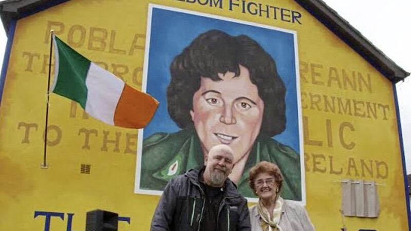 Bridie McBrearty and artist Kevin Hasson are pictured at a mural of her son George in Derry 