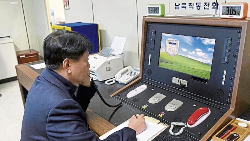 A South Korean official communicates with a North Korean officer during a phone call on the dedicated communications hotline at the border village of Panmunjom in Paju, South Korea, Wednesday PICTURE: Yonhap via AP 