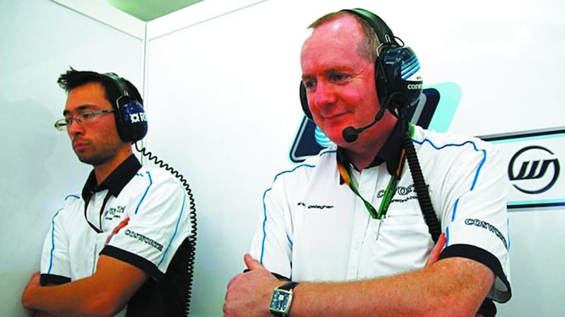 Mark Gallagher (right) keeps an eye on the racing in the A1GP World Cup of Motorsport