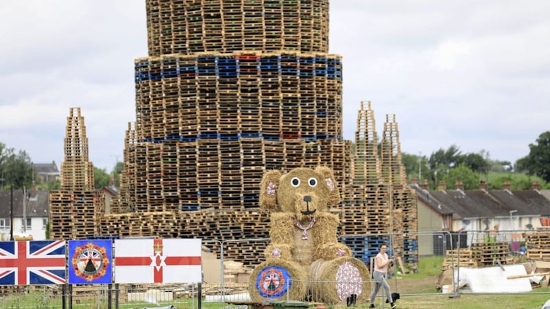 A massive bonfire in the shape of a castle with a large  teddy bear made from bales in Portadown 